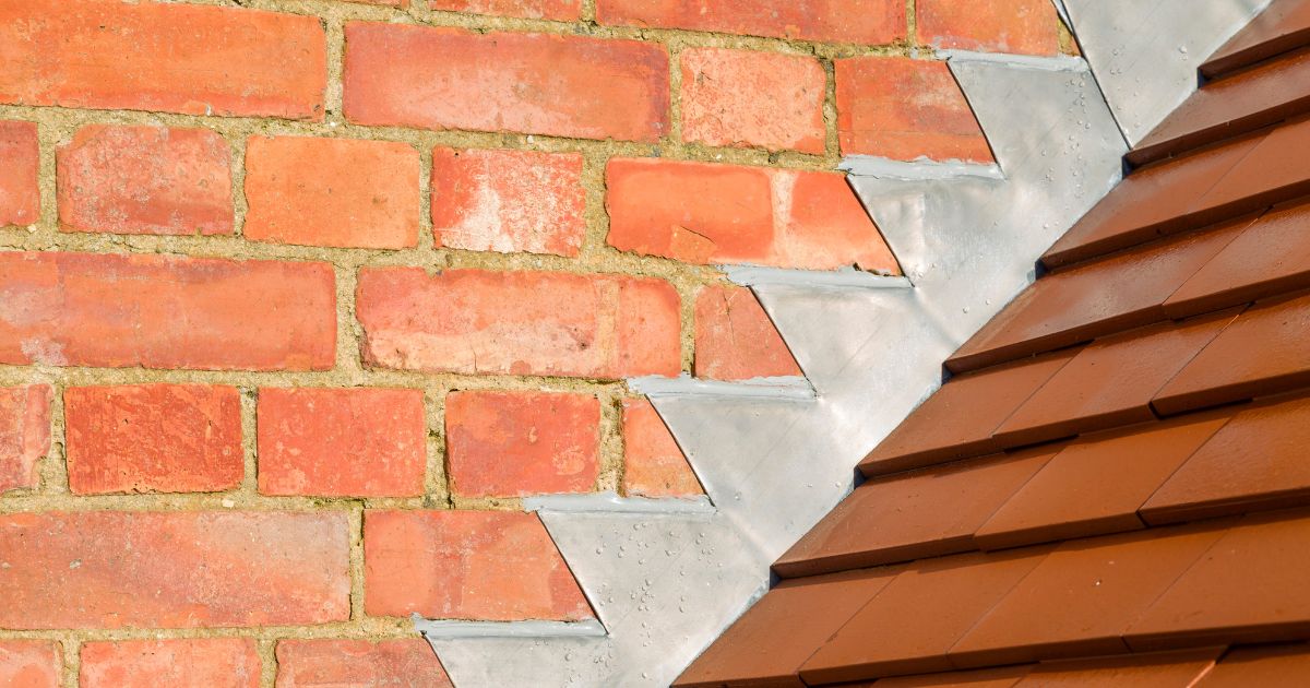 chimney flashing going up a red masonry wall