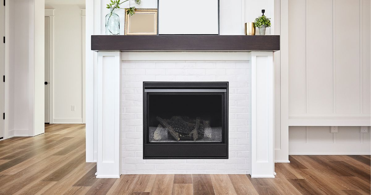 a white fireplace surround with a gas fireplace