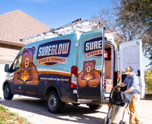 %Title% | Sureglow Stove &Amp; Chimney A SureGlow van with a technician at the back, getting equipment out to perform a chimney sweep